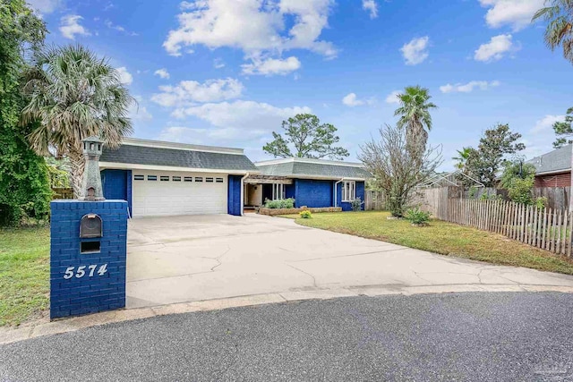 single story home featuring a garage and a front lawn