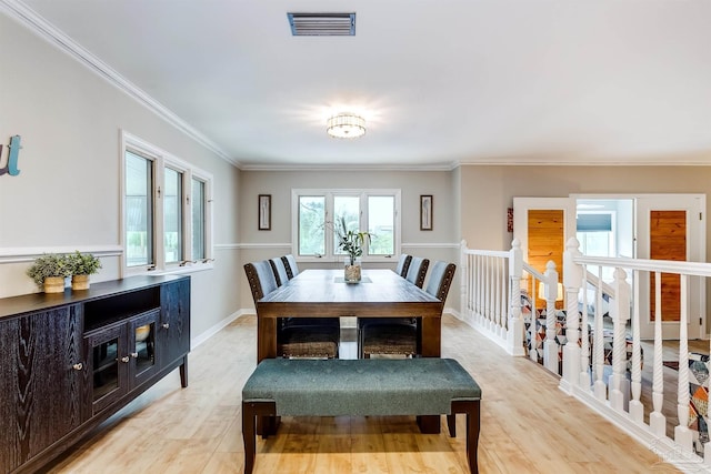 dining room with light hardwood / wood-style floors and ornamental molding