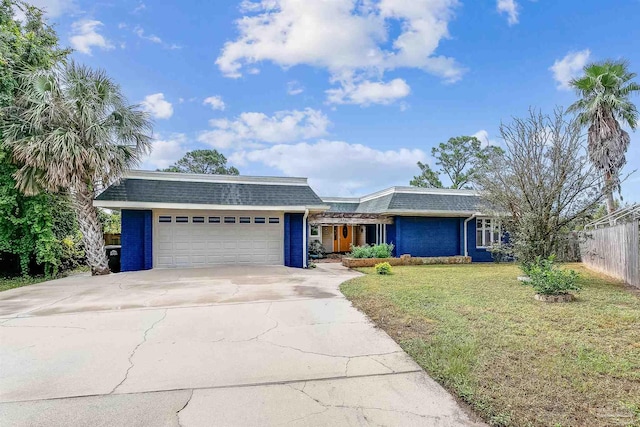 ranch-style house featuring a garage and a front yard