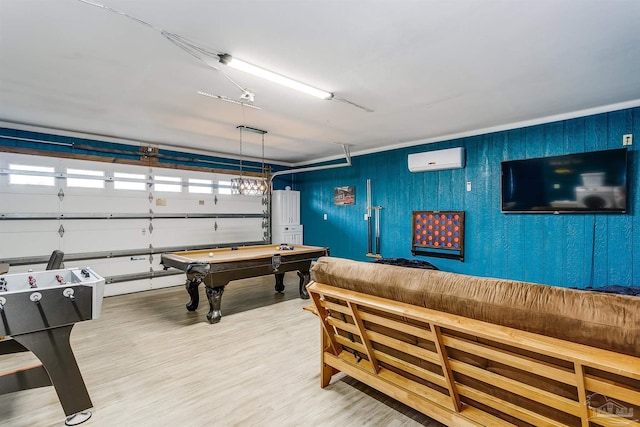 recreation room with a wall mounted air conditioner, hardwood / wood-style flooring, baseboard heating, and billiards