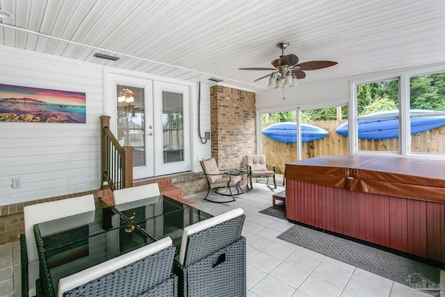 view of patio with ceiling fan, french doors, and a hot tub