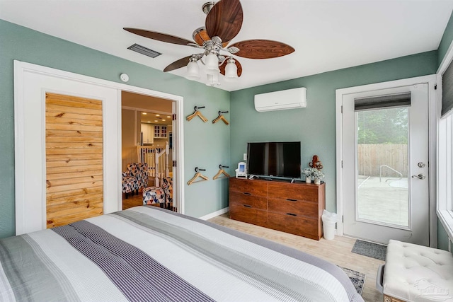 bedroom featuring ceiling fan, a closet, wood-type flooring, and a wall mounted air conditioner