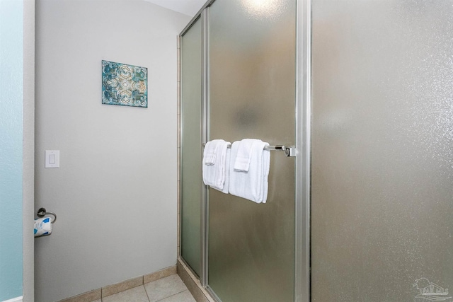 bathroom with tile patterned flooring and a shower with shower door