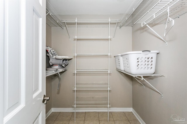 spacious closet featuring tile patterned flooring