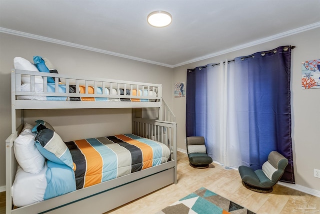 bedroom featuring hardwood / wood-style flooring and ornamental molding