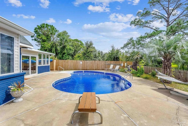 view of swimming pool featuring a patio area