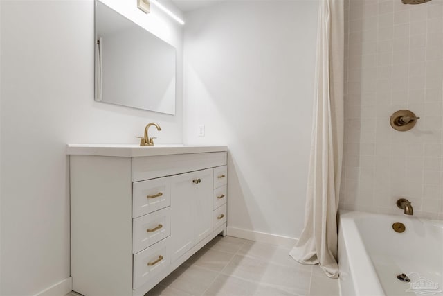 full bath featuring vanity, tile patterned flooring, baseboards, and shower / tub combo with curtain