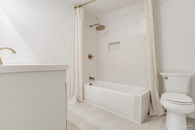 bathroom featuring tile patterned floors, shower / bath combo with shower curtain, and toilet