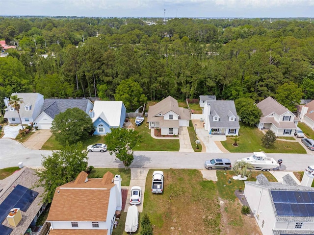 birds eye view of property featuring a forest view and a residential view