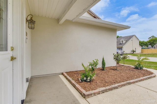 property entrance with stucco siding