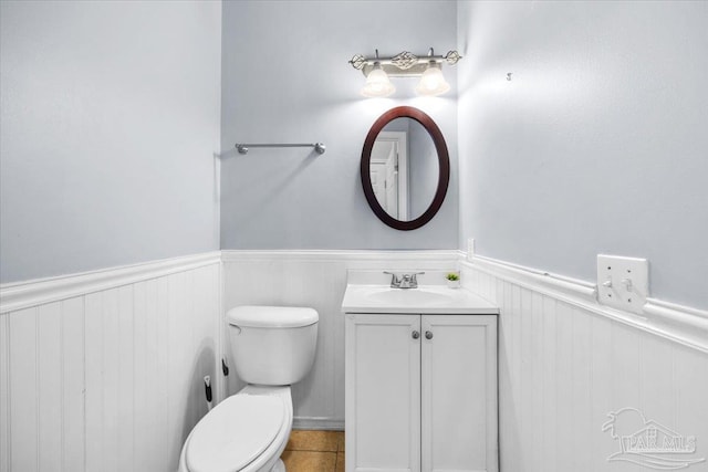 bathroom with tile patterned floors, vanity, and toilet