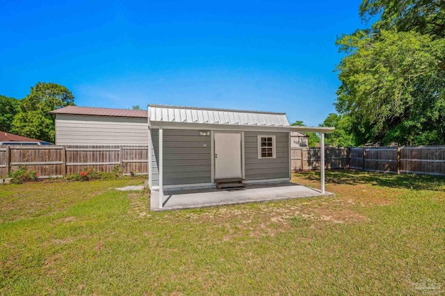 exterior space with a fenced backyard and an outdoor structure