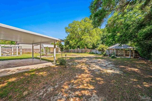 view of yard featuring a fenced backyard, a gazebo, and a patio area