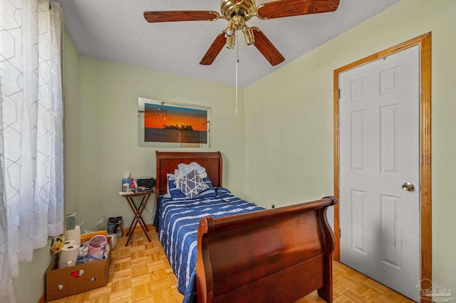 bedroom featuring a textured ceiling and ceiling fan