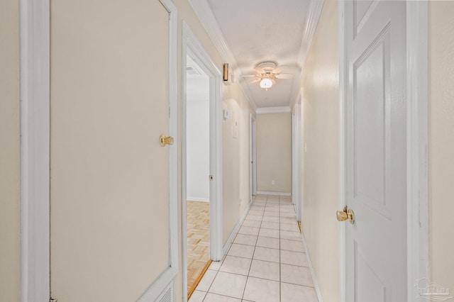 hallway with ornamental molding, light tile patterned flooring, and baseboards