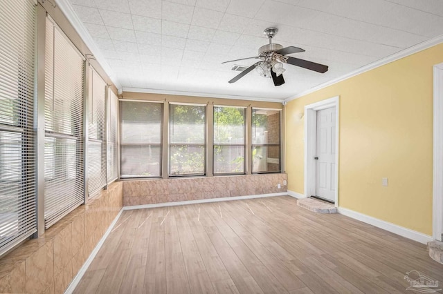 interior space featuring hardwood / wood-style floors, ornamental molding, visible vents, ceiling fan, and baseboards
