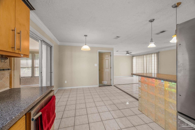 kitchen with a textured ceiling, ornamental molding, visible vents, and plenty of natural light