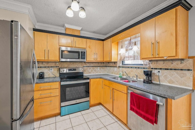 kitchen with a sink, stainless steel appliances, a textured ceiling, crown molding, and dark countertops