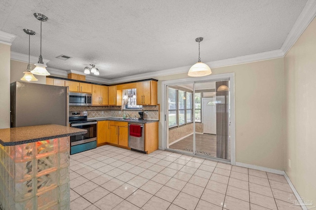 kitchen with dark countertops, stainless steel appliances, visible vents, tasteful backsplash, and ornamental molding