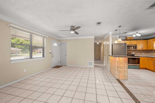 kitchen with crown molding, stainless steel appliances, tasteful backsplash, and visible vents