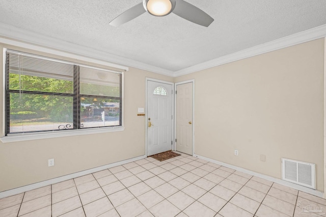 entrance foyer featuring ornamental molding, a textured ceiling, visible vents, a ceiling fan, and baseboards