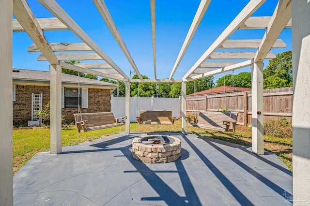 view of patio / terrace featuring a pergola, a fenced backyard, and a fire pit