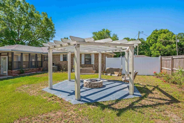 view of yard with a pergola, a patio area, a fenced backyard, and a fire pit