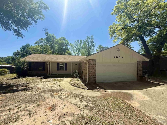 ranch-style home featuring concrete driveway, brick siding, and a garage