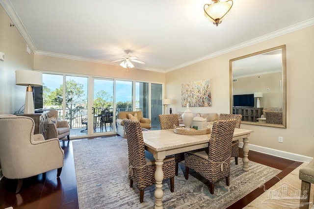 dining space featuring crown molding, baseboards, and dark wood-type flooring