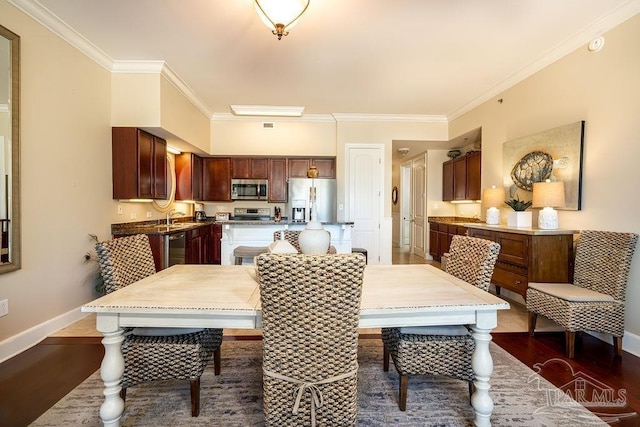 dining room featuring crown molding, dark wood finished floors, and baseboards