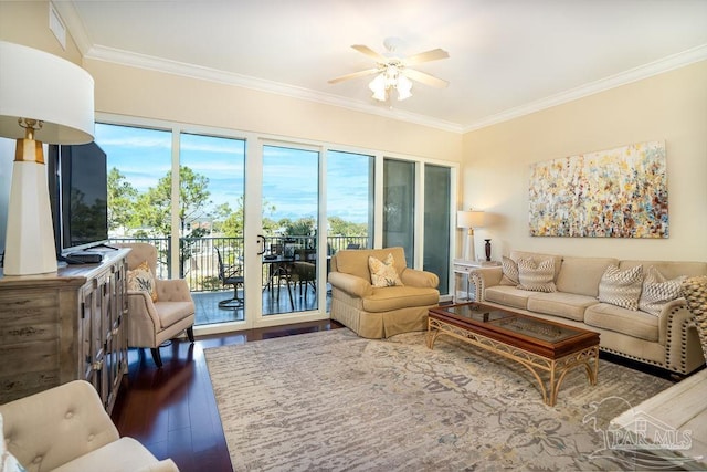 living room featuring ornamental molding, a wealth of natural light, and wood finished floors