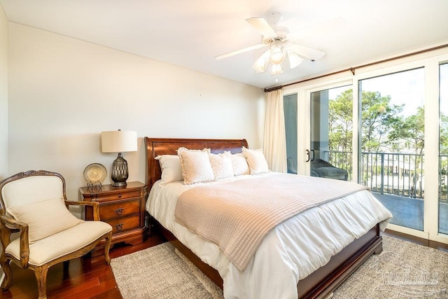 bedroom featuring a ceiling fan, access to outside, expansive windows, and wood finished floors