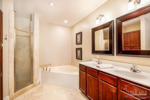 full bathroom with a bath, a shower stall, double vanity, and a sink