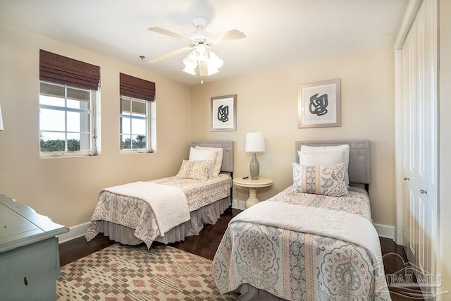 bedroom with ceiling fan, wood finished floors, and baseboards