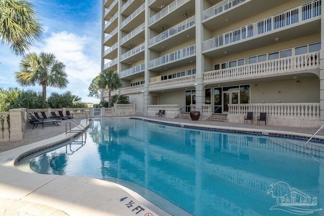 community pool with a patio area