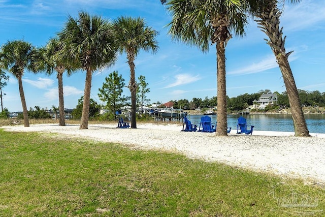 view of community featuring a water view and a yard