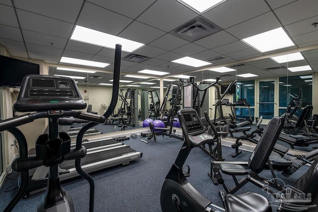 workout area featuring a paneled ceiling and visible vents