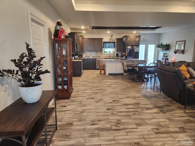 interior space featuring a tray ceiling and sink