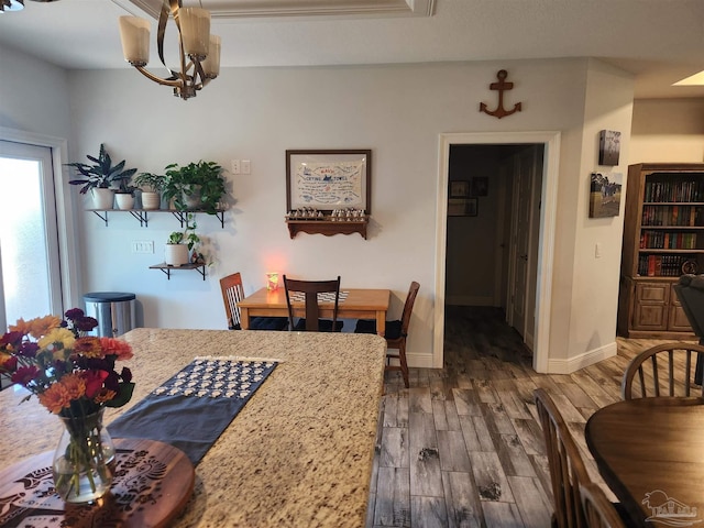 dining area featuring dark hardwood / wood-style floors and a notable chandelier