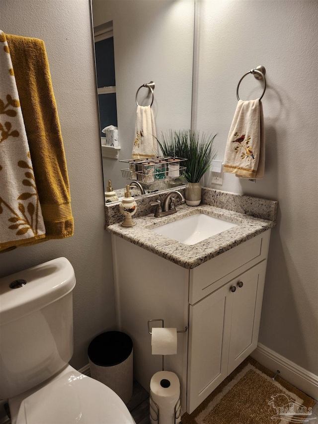 bathroom featuring vanity and toilet