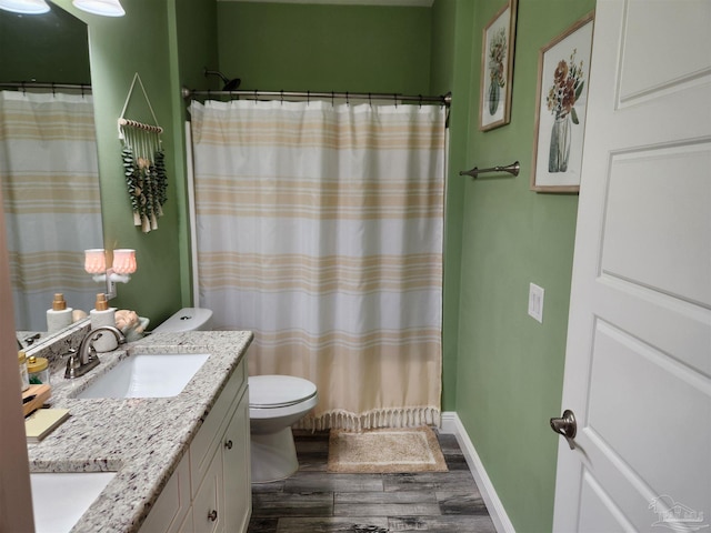 bathroom featuring hardwood / wood-style flooring, vanity, toilet, and a shower with shower curtain