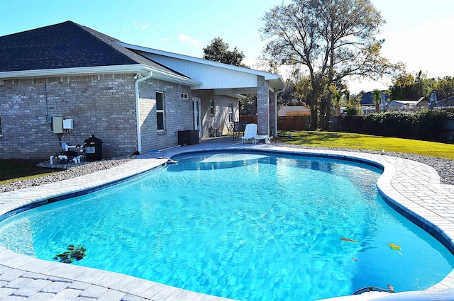 view of pool with a yard and a patio area