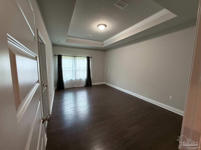 7912 Stream Ridge Rd, Pensacola, FL 32526 - empty room featuring a raised ceiling, ornamental molding, baseboards, a textured ceiling, and dark wood-style floors