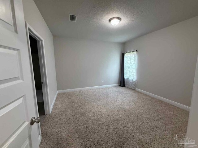 7912 Stream Ridge Rd, Pensacola, FL 32526 - carpeted spare room featuring a textured ceiling and baseboards