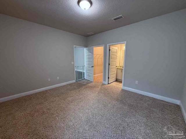 7912 Stream Ridge Rd, Pensacola, FL 32526 - unfurnished bedroom with a textured ceiling, light colored carpet, baseboards, a spacious closet, and a closet