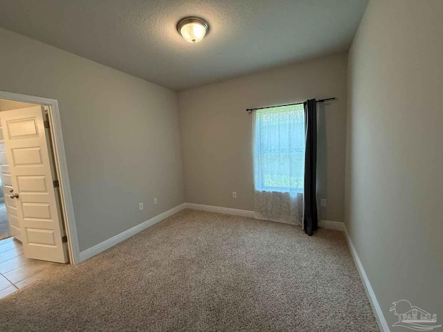 7912 Stream Ridge Rd, Pensacola, FL 32526 - empty room with light carpet, baseboards, and a textured ceiling