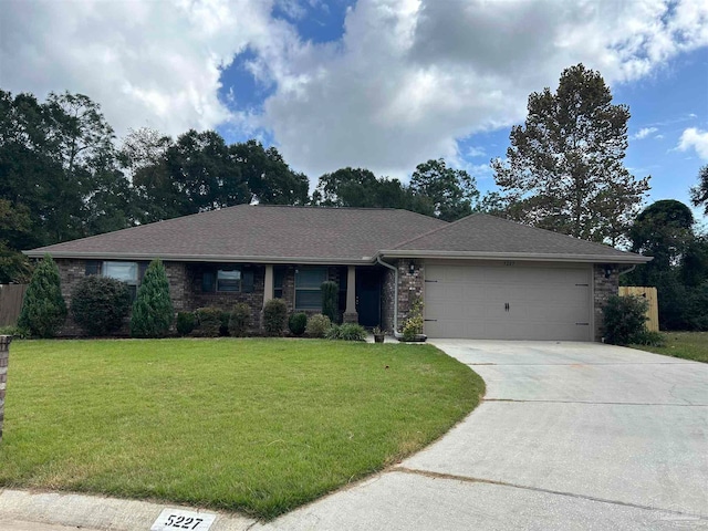 single story home with a garage and a front lawn