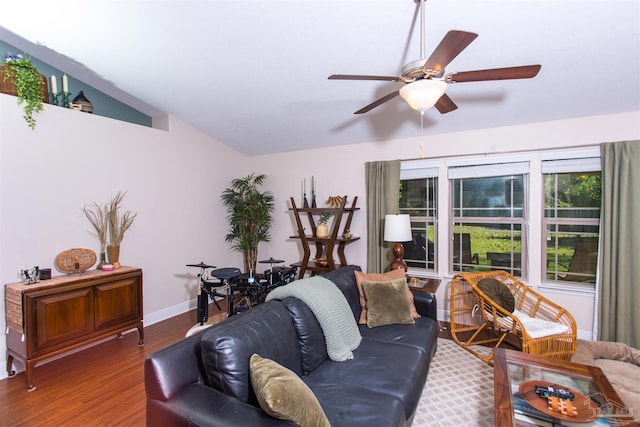 living room with wood-type flooring, vaulted ceiling, and ceiling fan