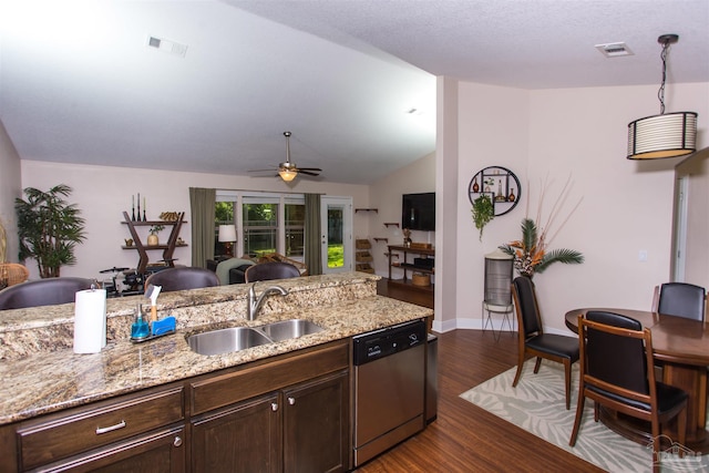 kitchen with sink, light stone counters, stainless steel dishwasher, dark hardwood / wood-style floors, and lofted ceiling