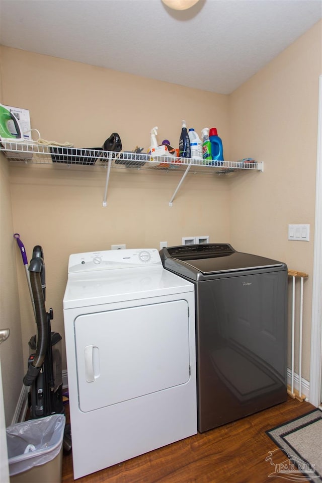 laundry area featuring dark hardwood / wood-style floors and washing machine and dryer